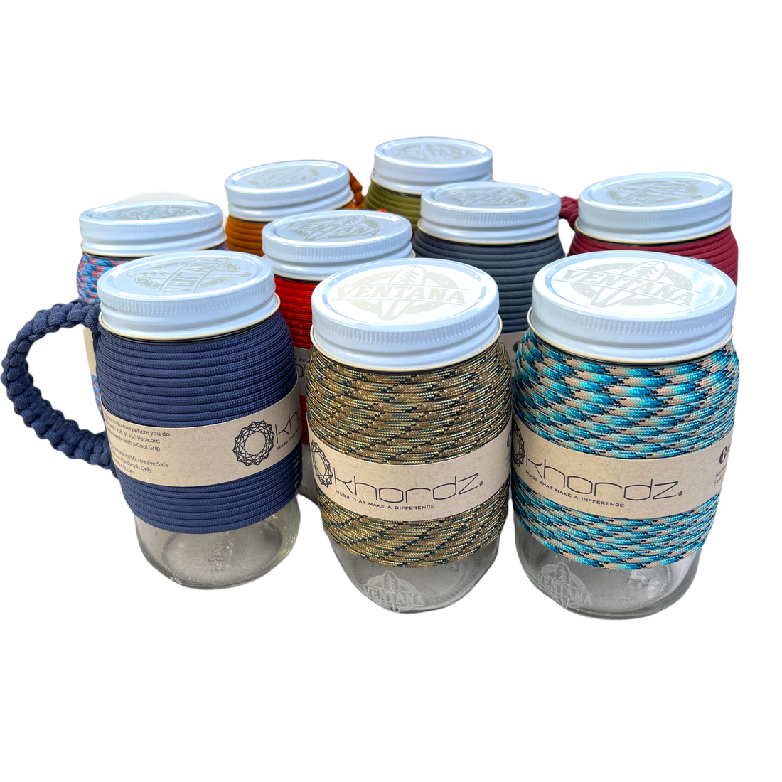 Set of glass jars with colorful rope cozies and white lids on a white background